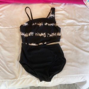 I am selling a black and white swim suit with a cut off on the left side